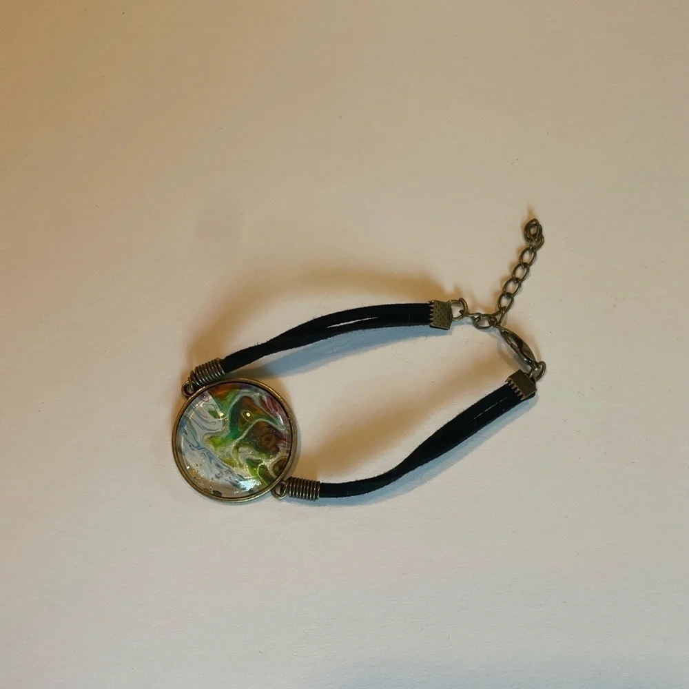 Hand painted acrylic on glass & attached to metal.  Adjustable